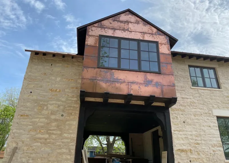 Copper metal panel facade on a stone building for Skylight Installation in Palmer Ranch