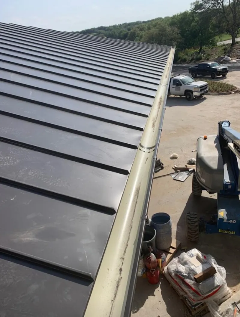 Standing seam panel and gutter detail on a metal roofing jobsite in Palmer Ranch